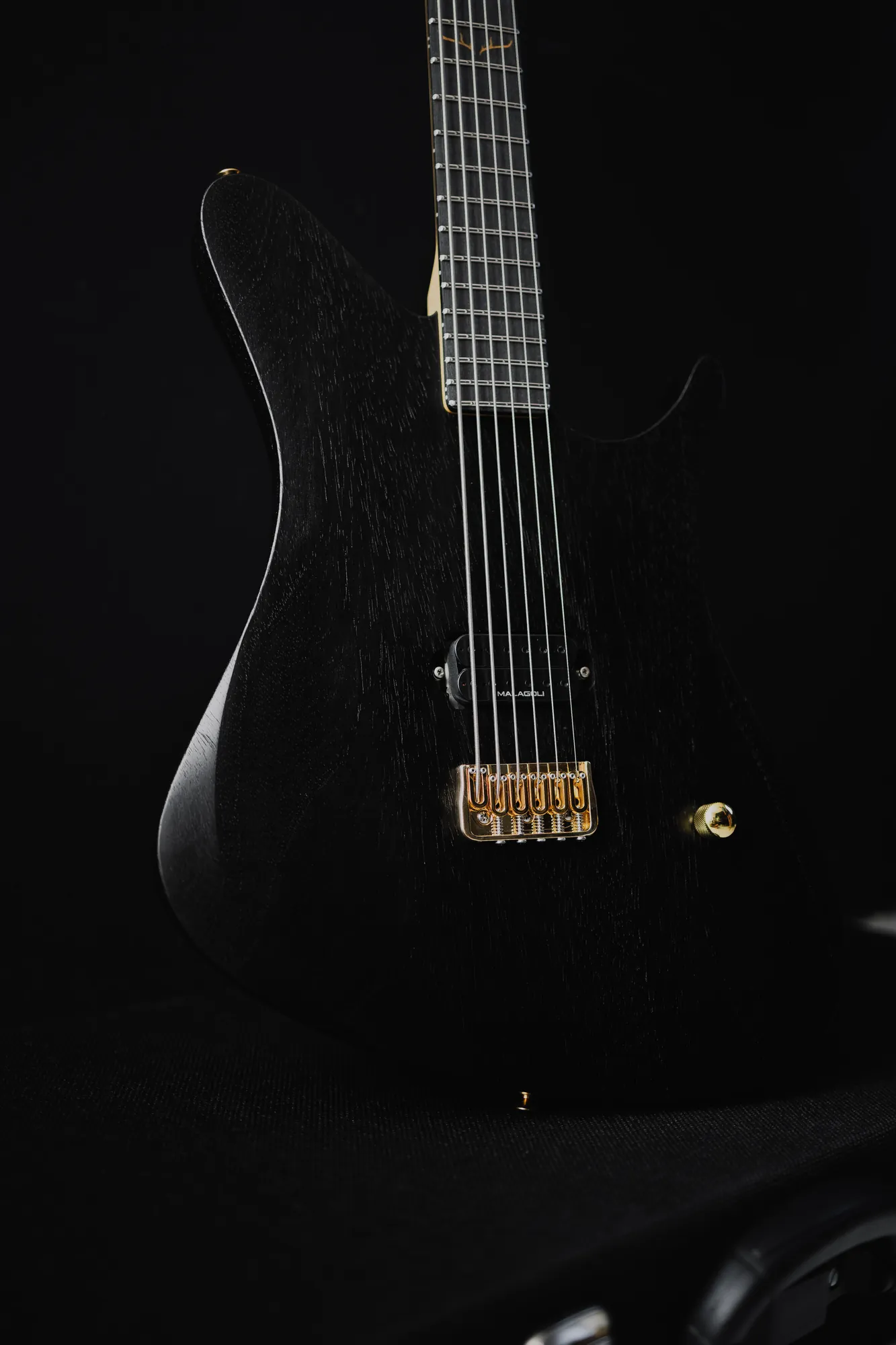 The Pan 630 in black, front view, with gold hardware